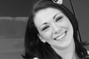 Black and white photo of a woman smiling Dentist Near Me